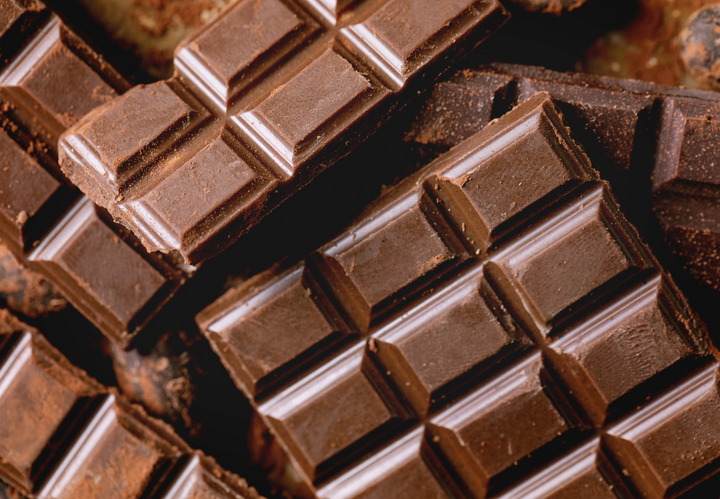 Close-up of broken dark chocolate bars with textured squares.